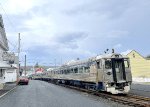 The three car RDC set, with the 9168 leading, heads south along the right of way within the median of S. Crescent St 